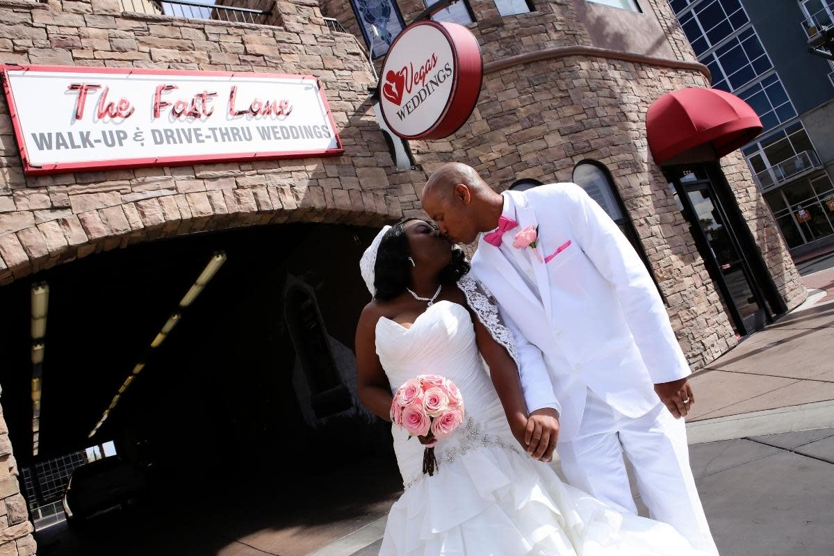 A newly married couple taking photos at Fast Lane at the Wedding Chapel of Las Vegas