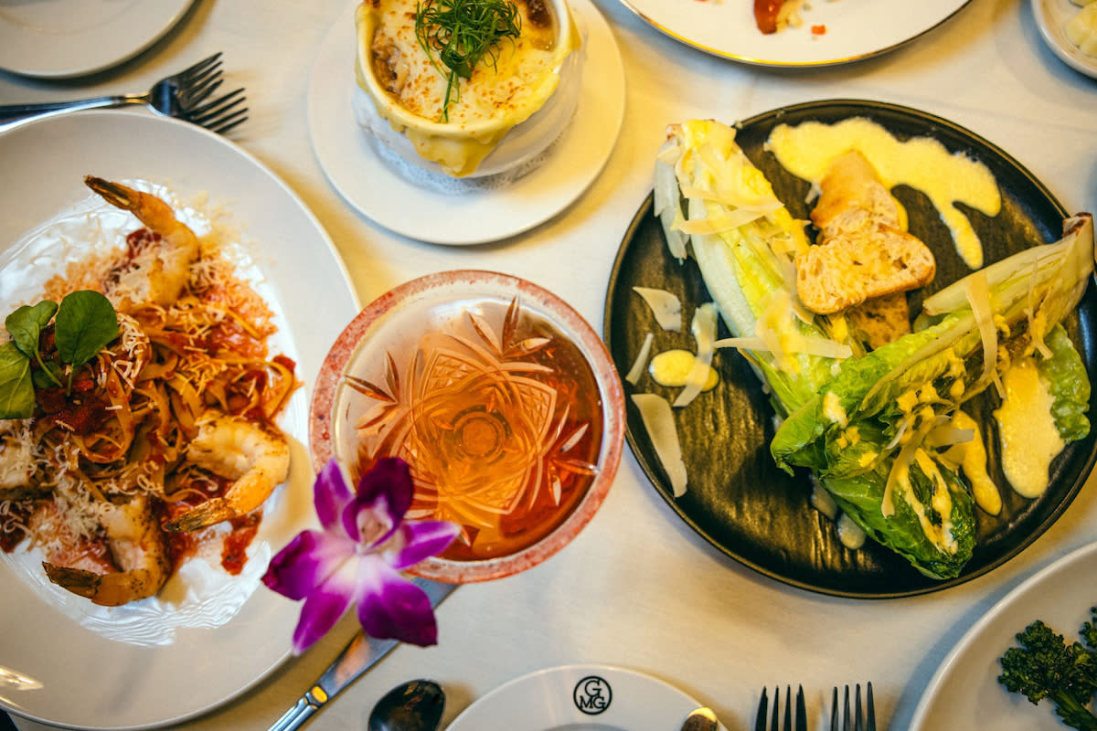 A close up of delicious dishes and cocktail at Gregory's Mesquite Grill.