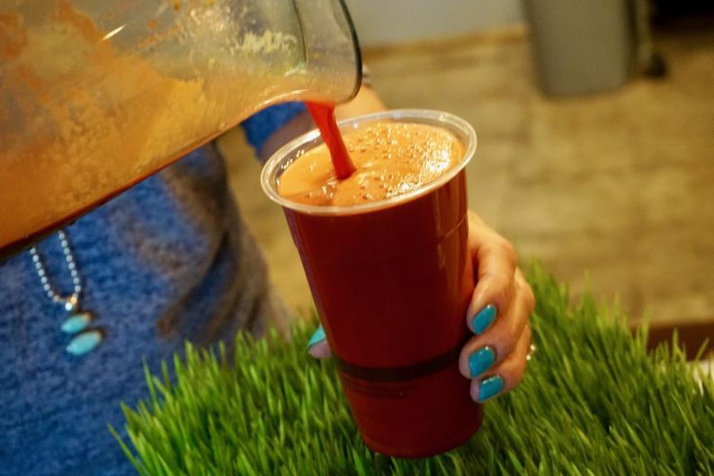 Pouring a smoothie at Sip Juice Bar