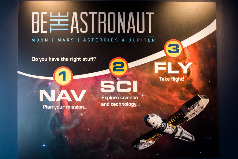 The Be the Astronaut exhibit is split into three categories: Nav - Plan your mission, Sci - Explore science and technology, and Fly - Take flight!