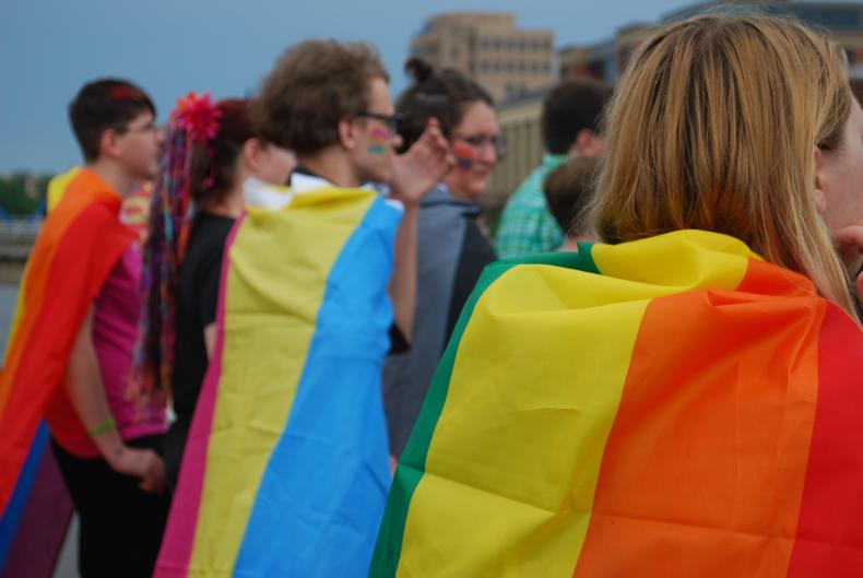 Several Pride Festival Attendees in Grand Rapids wearing Pride Flags as capes