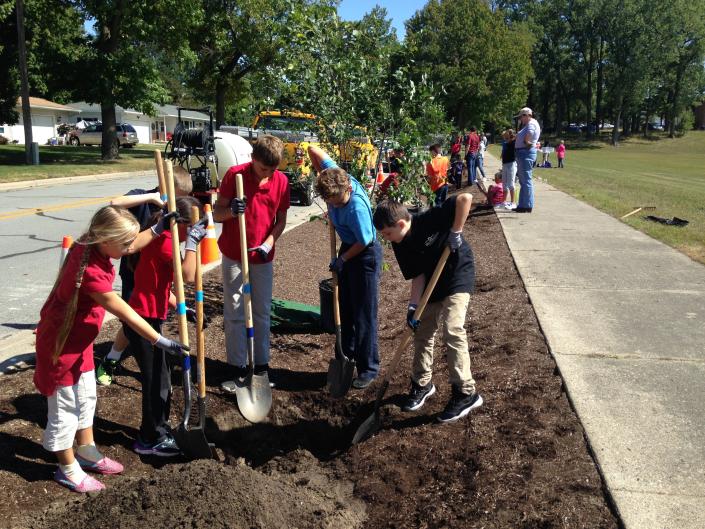 Kids and adults of all ages planting trees with Lower Grand River Organization of Watersheds (LGROW).