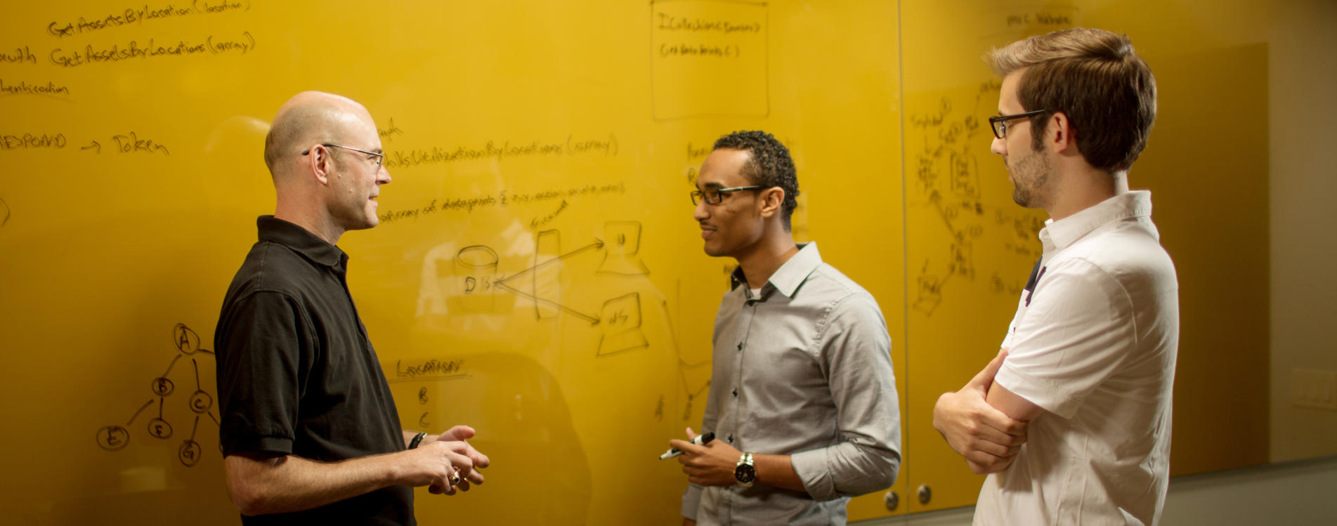Workers at Open Systems Technologies working on a problem.