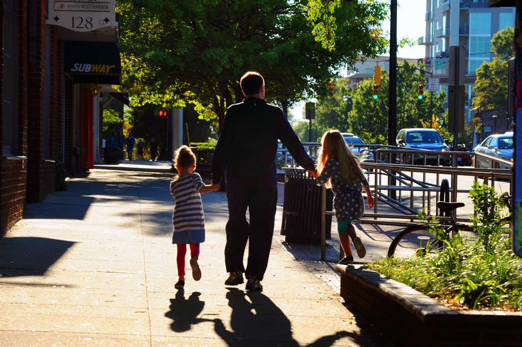 Dad and Kids walking down Franklin Street