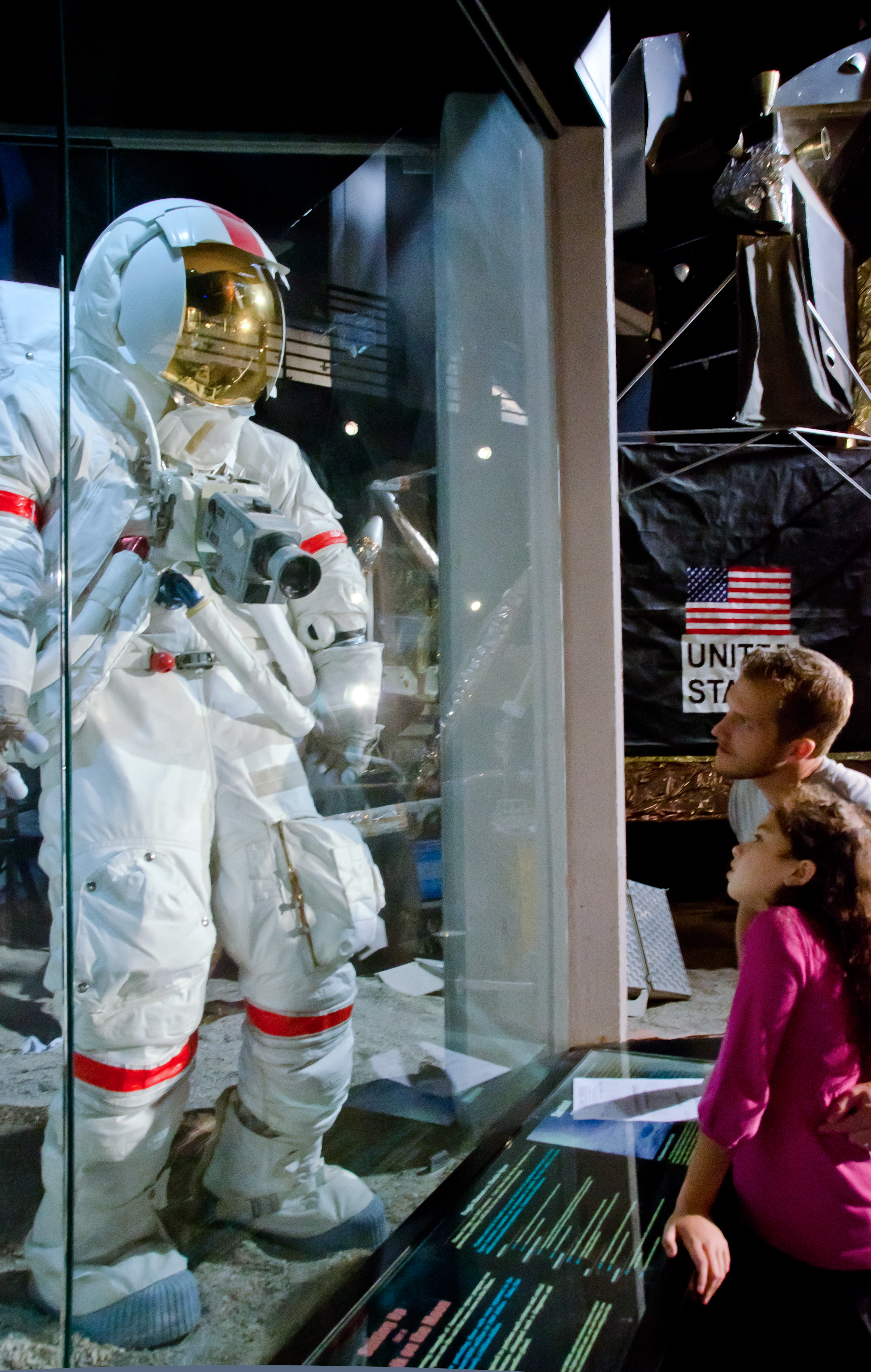 A father and daughter looking at a spacesuit at the Cosmosphere in Hutchinson