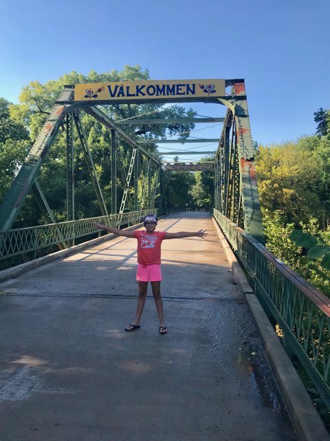 Girl Standing on Valkommen Trail Bridge in Kansas