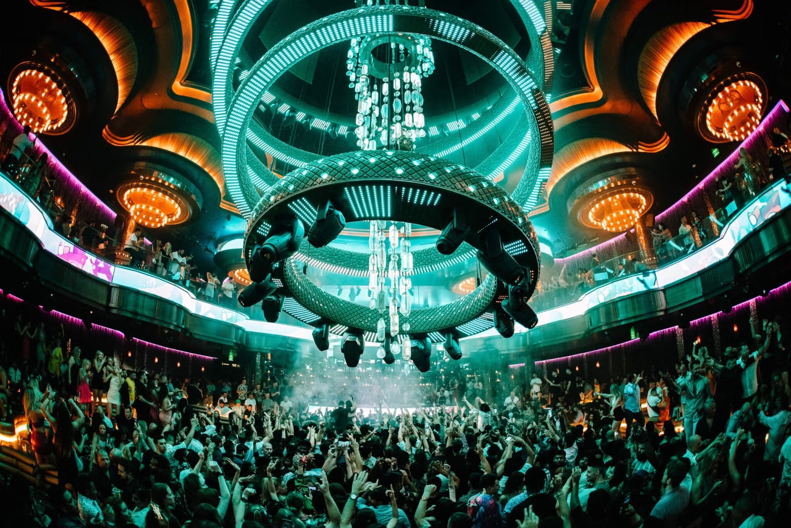 OMNIA Nightclub at Caesars Palace with iconic kinetic chandelier and glowing dance floor
