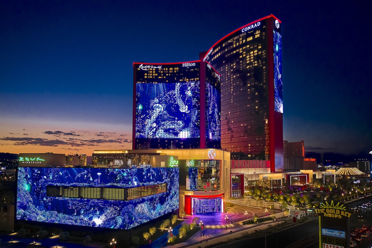 Resorts World Las Vegas exterior with Conrad and Hilton towers and LED screen