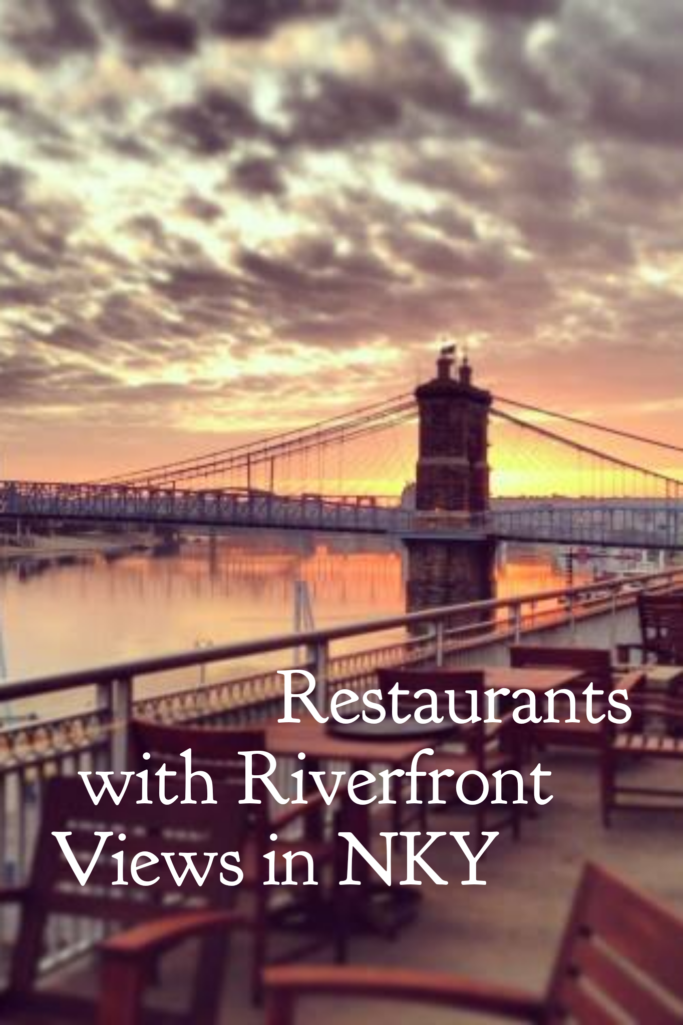 The Roebling suspension bridge at sunrise with a restaurant patio in the foreground and the title Restaurants with Riverfront Views in NKY