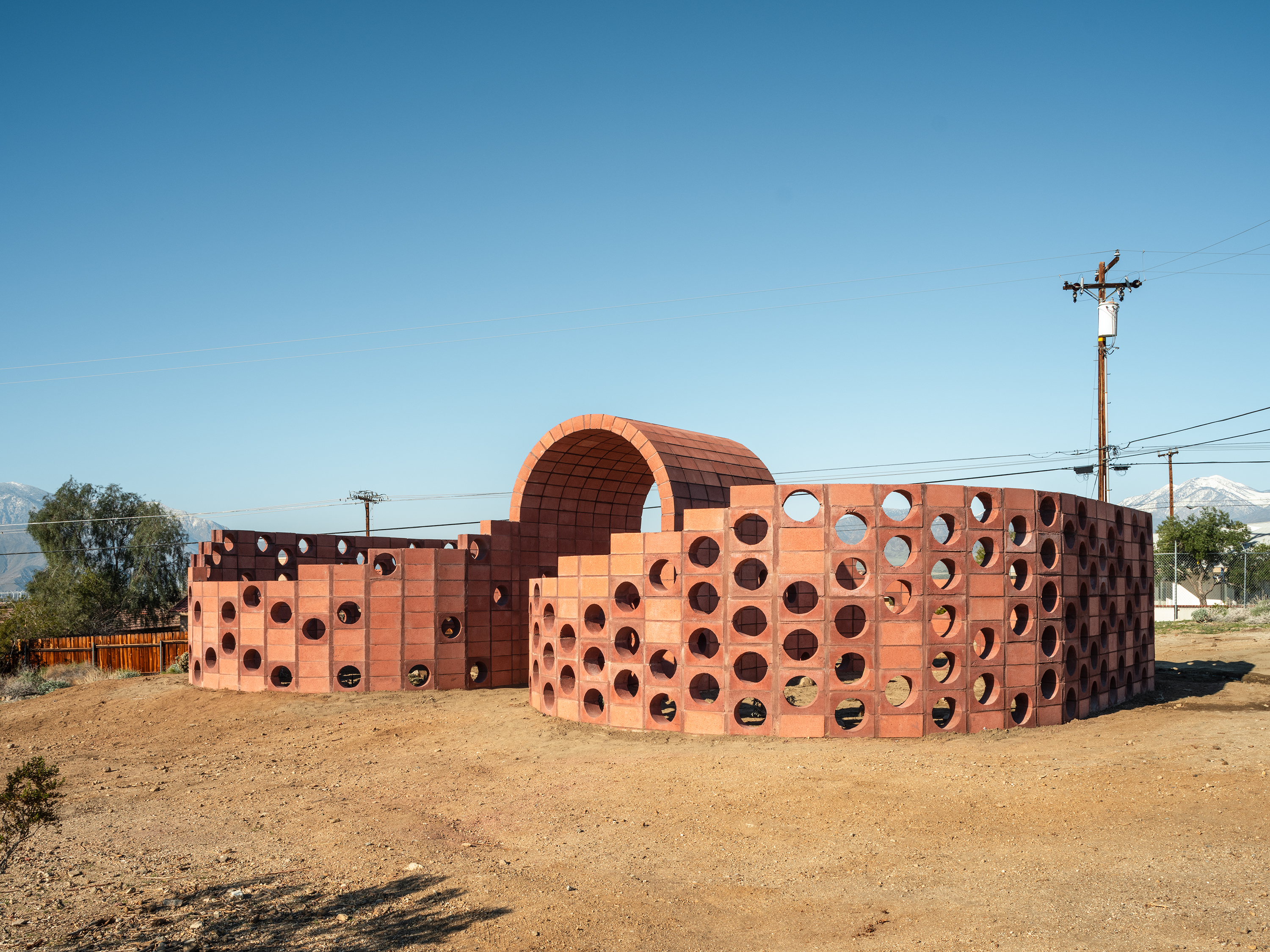 A brick-colored art installation in the desert