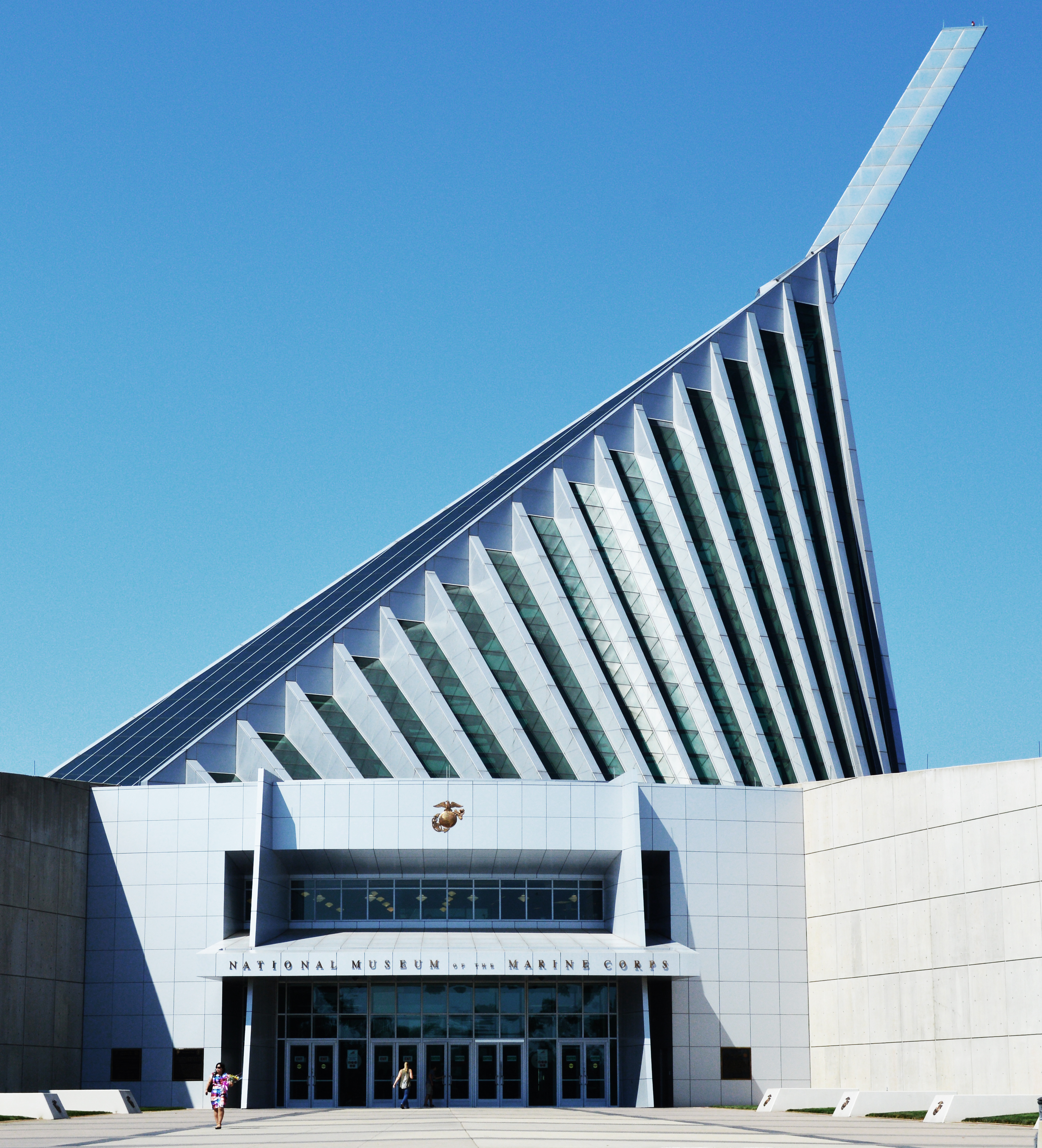 A white building with an off-center triangle roof