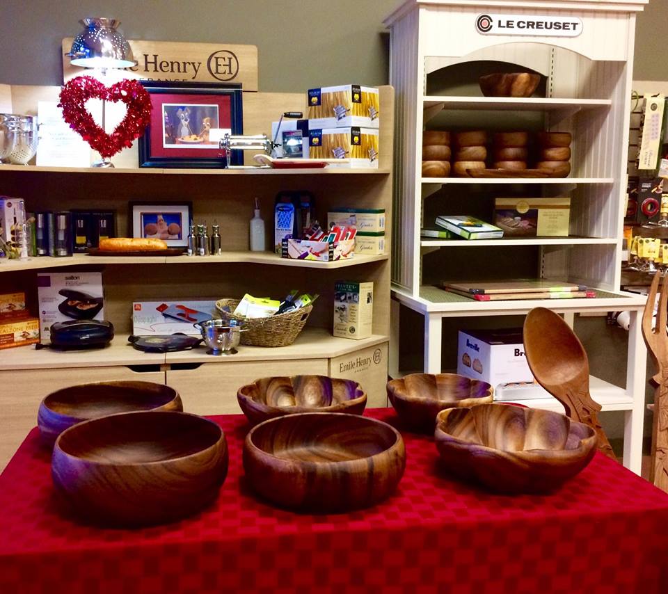 Compliments to the Chef table with display of wooden bowls for sale with additional merchandise behind