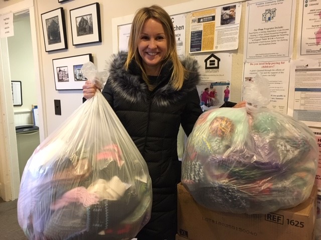 Woman holding two bags of donations