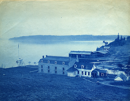 Buildings of the U.S. Penitentiary on McNeil Island, WA, circa 1890-91. Looking out over Tacoma Narrows. Washington State Historical Society, Springer Family Collection, C2014.165.1.