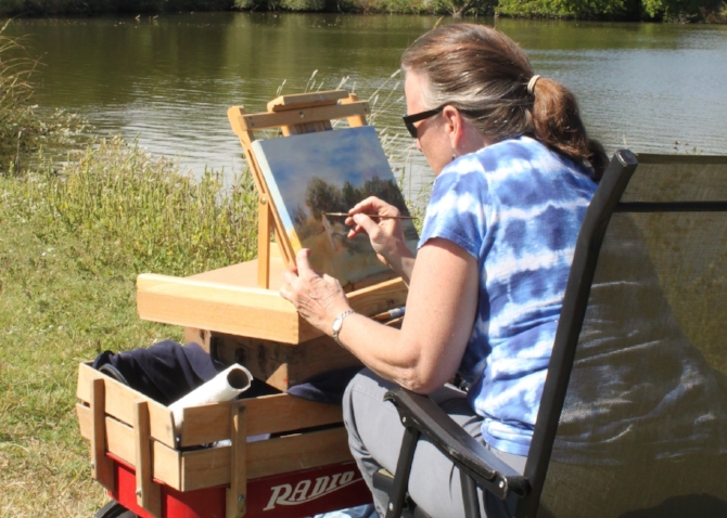 artists paints during art on the trail at great plains nature center in wichita ks