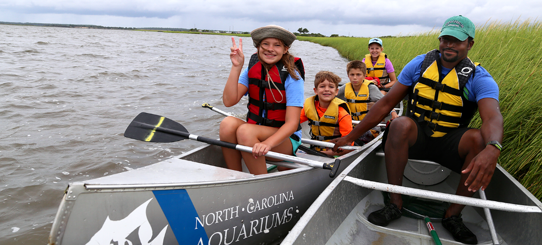 NC Aquarium Summer Camp kids Canoeing with volunteer